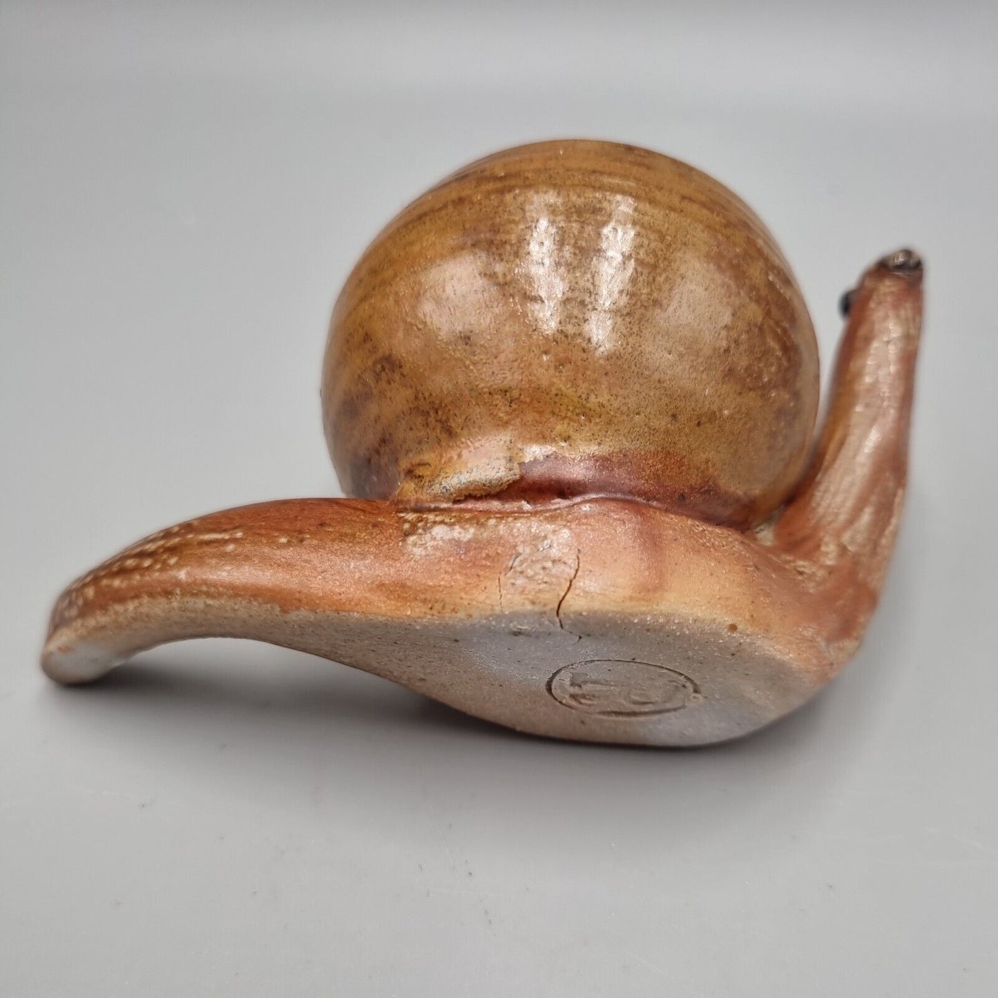 A Rowena Kinsman Studio Pottery 'Snail' Egg Cup Holder.