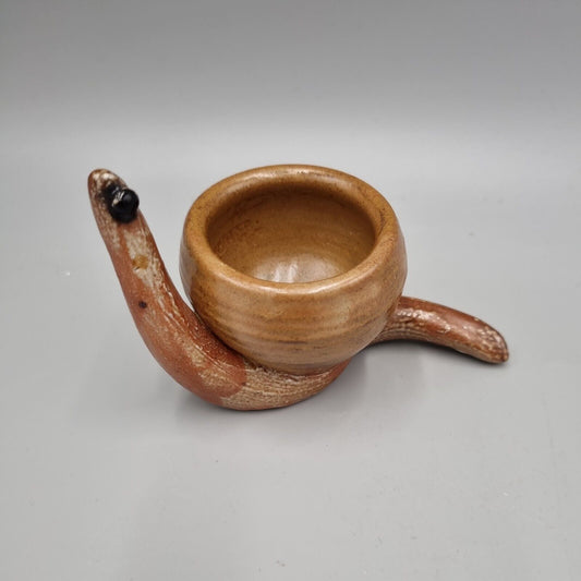 A Rowena Kinsman Studio Pottery 'Snail' Egg Cup Holder.