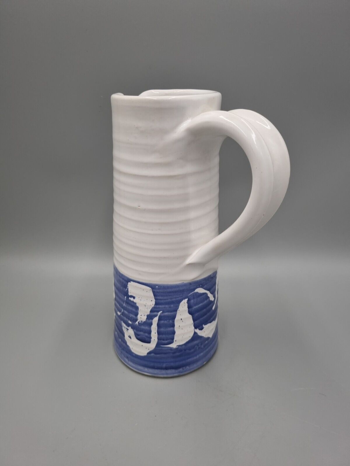 A Tall Studio Pottery Ribbed Jug / Pitcher, Unmarked.