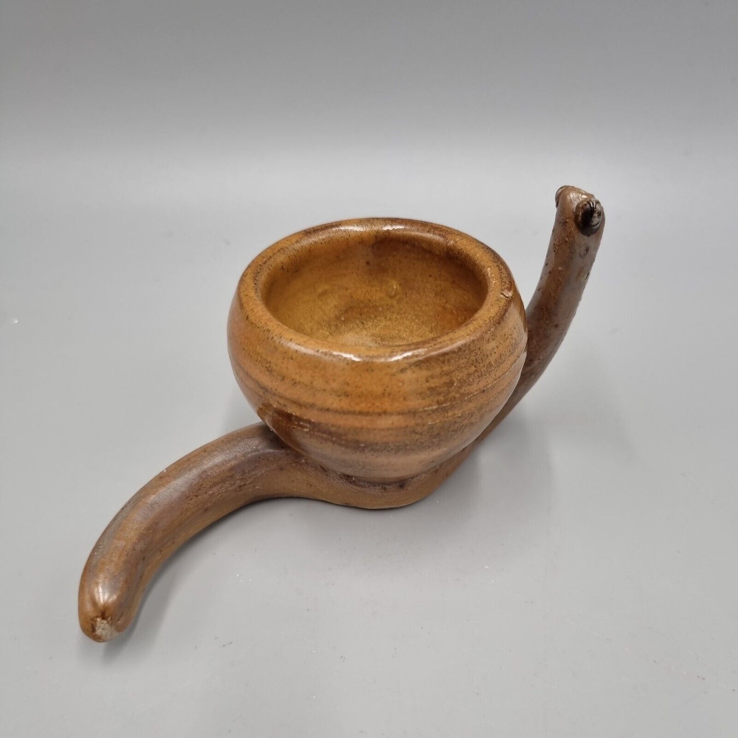 A Rowena Kinsman Studio Pottery 'Snail' Egg Cup Holder.