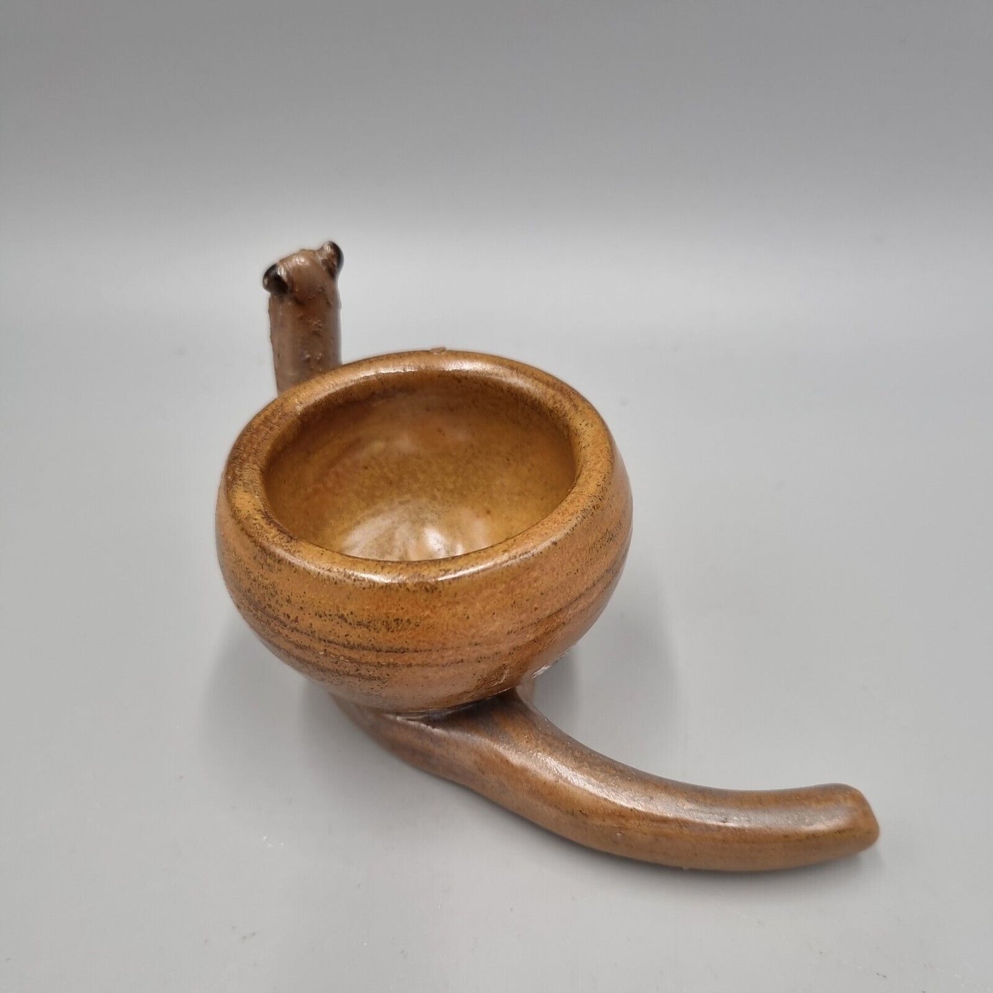 A Rowena Kinsman Studio Pottery 'Snail' Egg Cup Holder.