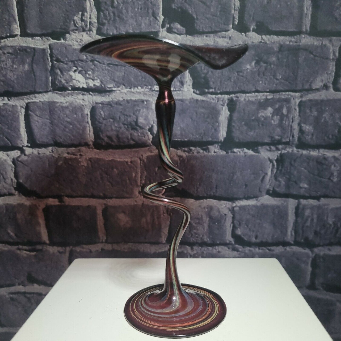 A single twisted stem art glass studio pedestal in deep purple / Amethyst.