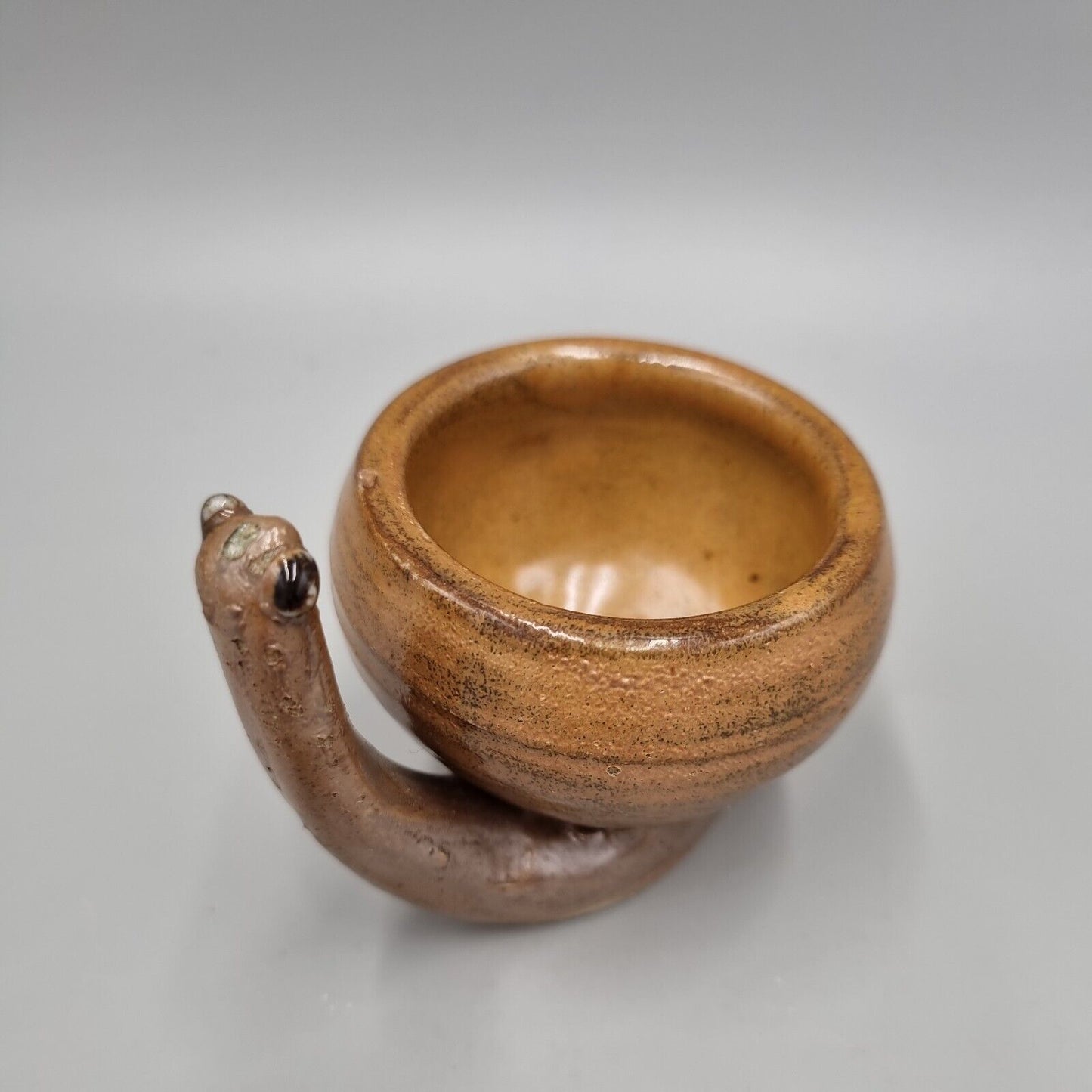 A Rowena Kinsman Studio Pottery 'Snail' Egg Cup Holder.