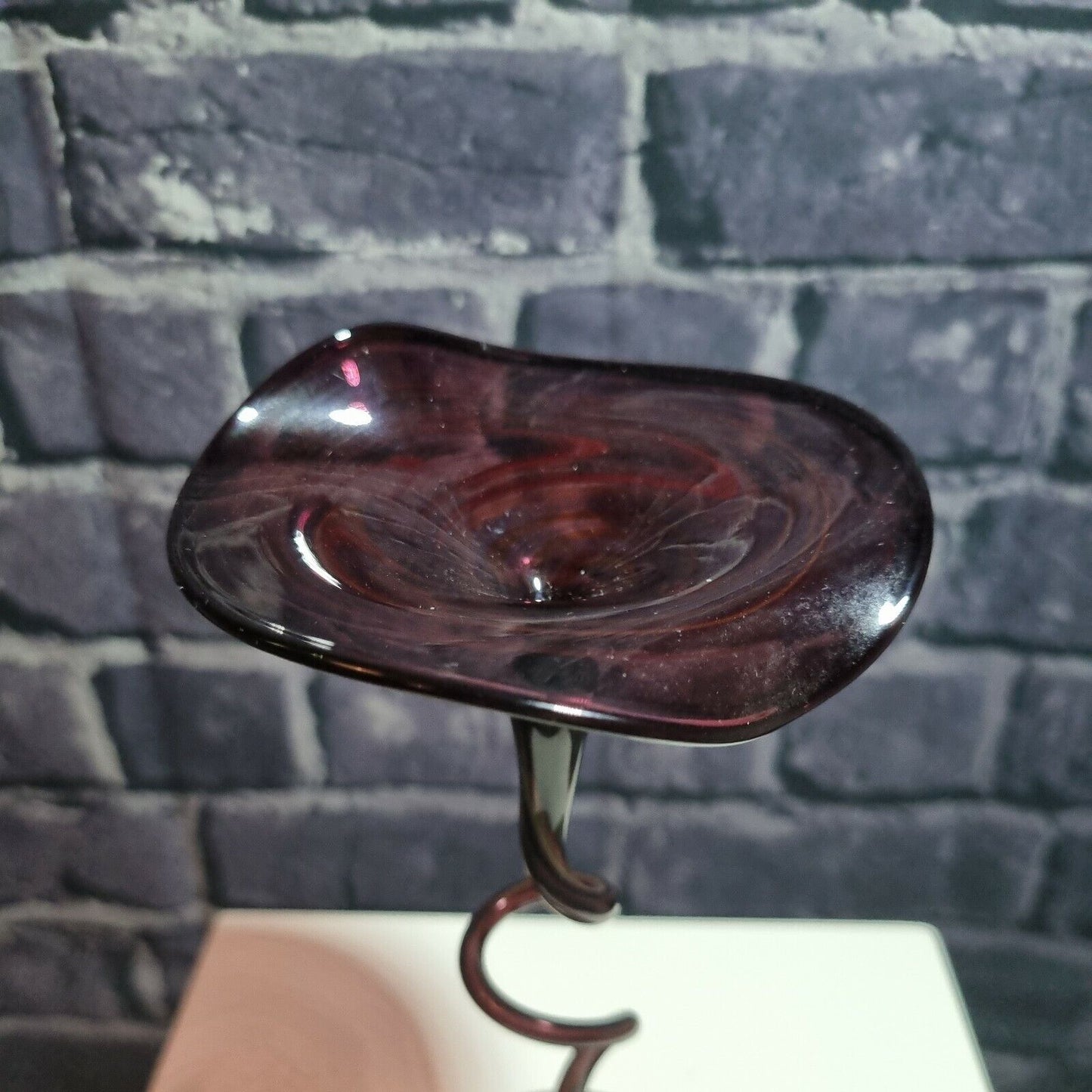 A single twisted stem art glass studio pedestal in deep purple / Amethyst.