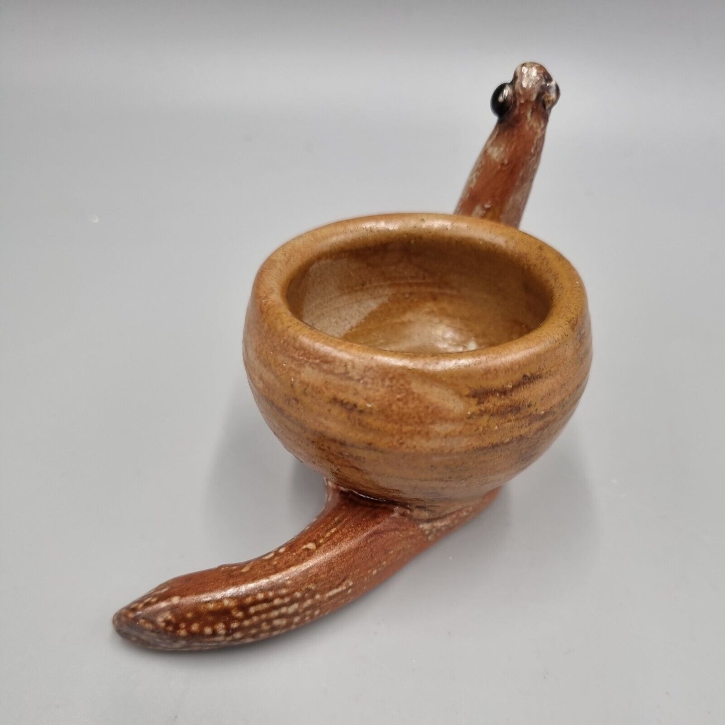 A Rowena Kinsman Studio Pottery 'Snail' Egg Cup Holder.