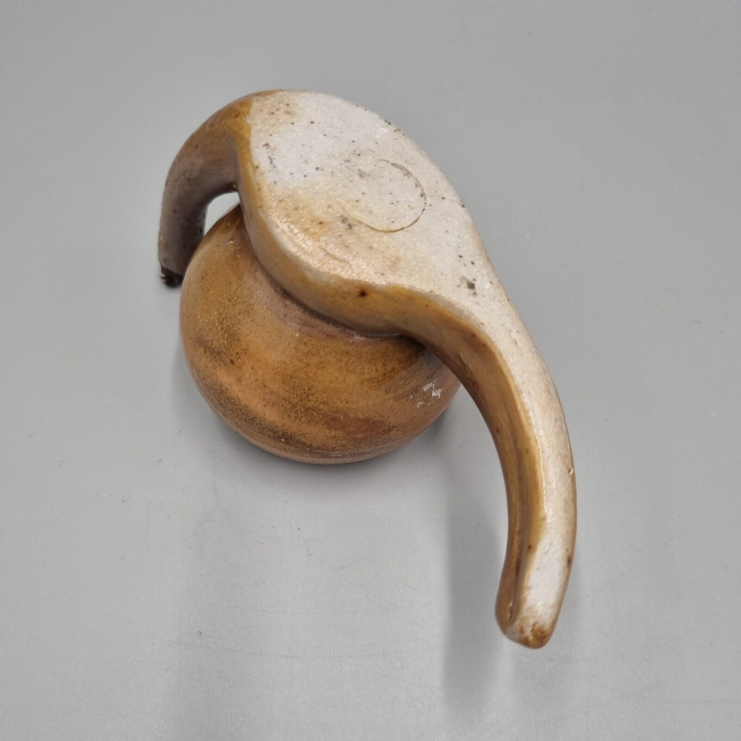 A Rowena Kinsman Studio Pottery 'Snail' Egg Cup Holder.