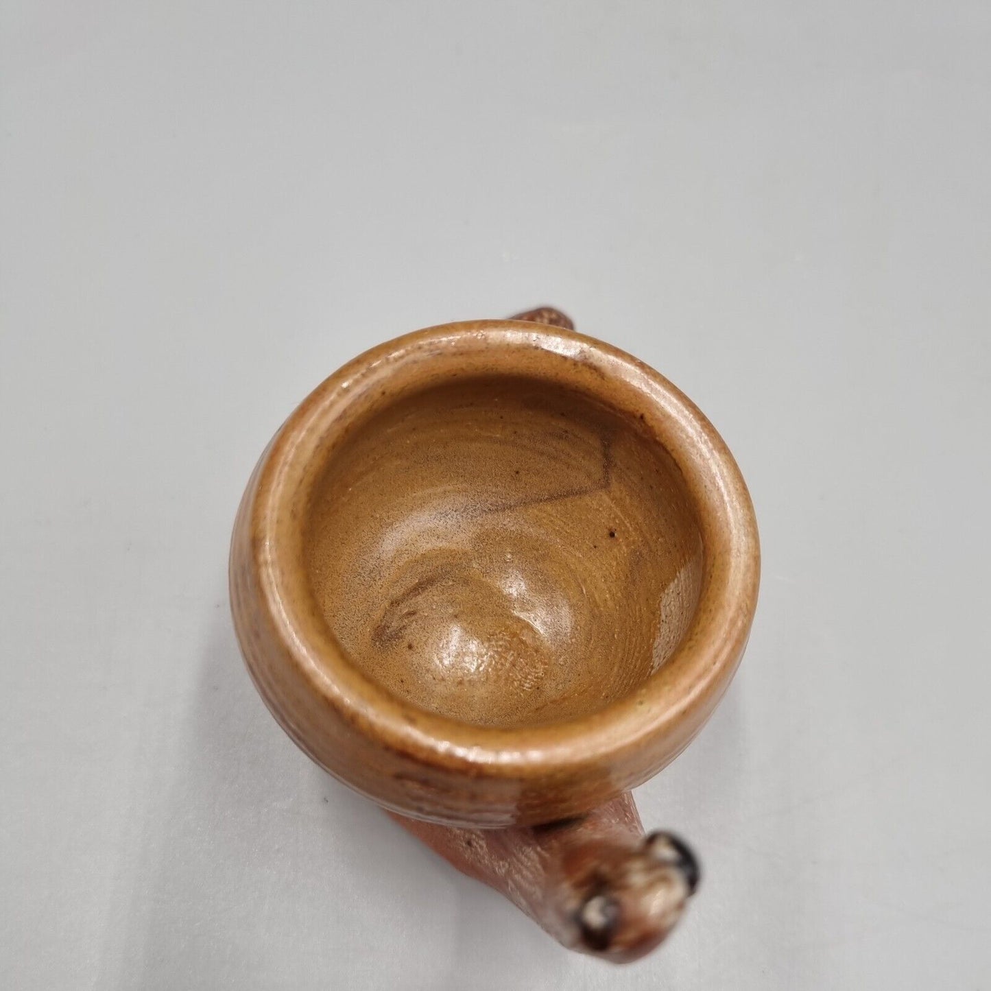 A Rowena Kinsman Studio Pottery 'Snail' Egg Cup Holder.