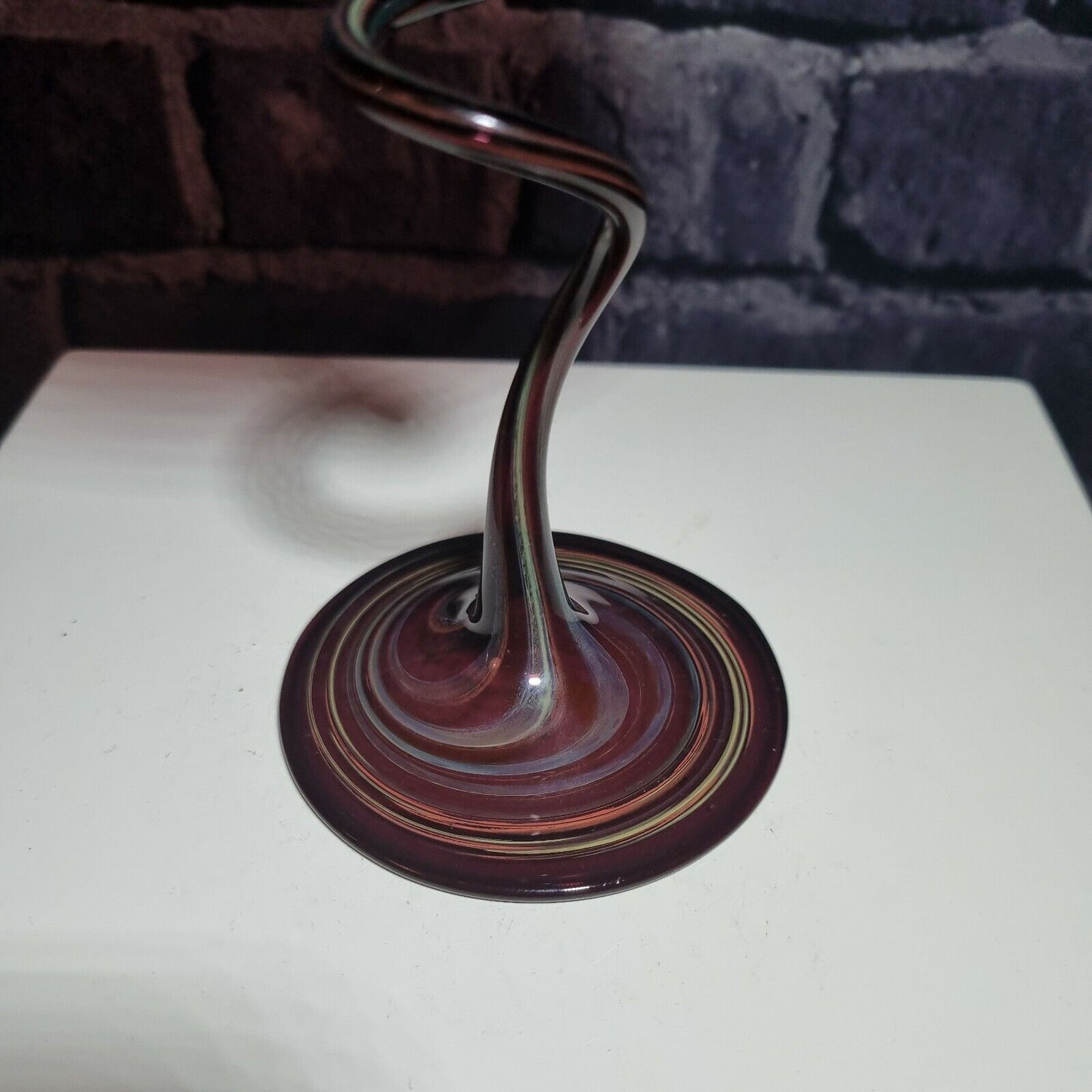 A single twisted stem art glass studio pedestal in deep purple / Amethyst.