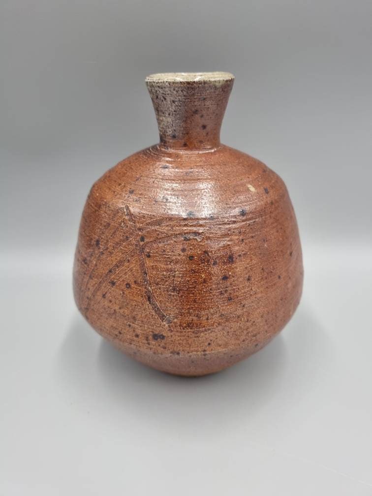 A William Marshall for Leach Pottery Bottle Vase With Iron Glaze And Incised Decoration.