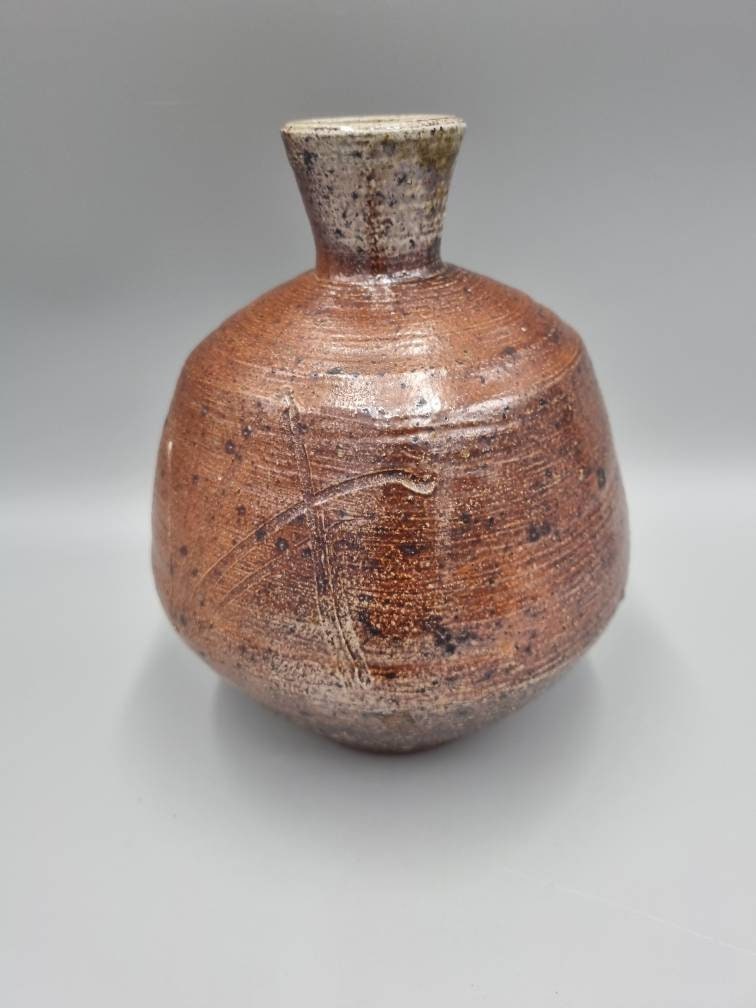 A William Marshall for Leach Pottery Bottle Vase With Iron Glaze And Incised Decoration.