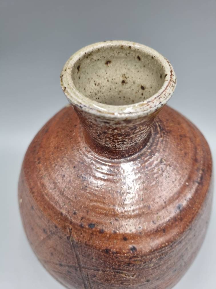 A William Marshall for Leach Pottery Bottle Vase With Iron Glaze And Incised Decoration.